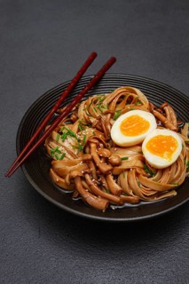 Buckwheat noodles soba with shimeji mushrooms, with boiled egg, green onion, sesame seeds,