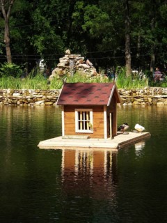Pond with bird house on the backdrop of an alphine slide in Gorky Park. One of the well-known