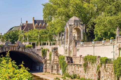 City park with large green wall, pagoda and underpass for the Vienna River, Vienna, Austria