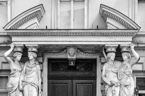 Women as supporting marble statues at a historic building, black and white photo, Josefsplatz,