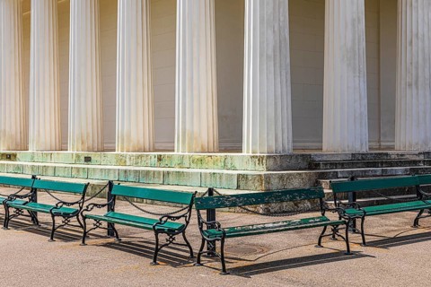 Columns of the Temple of Theseus, with green benches in front of it, Volksgarten, Vienna, Austria