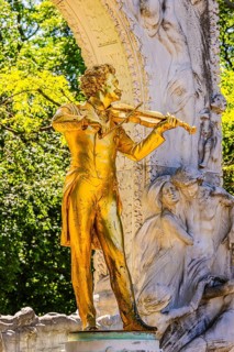 The gilded bronze statue of Johann Strauss, the Waltz King, memorial in the municipal park, Vienna,