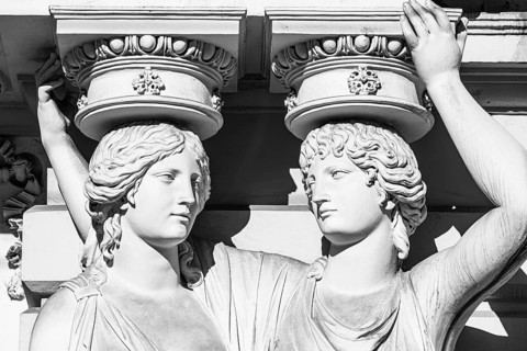Women as supporting marble statues at a historic building, black and white photo, Josefsplatz,