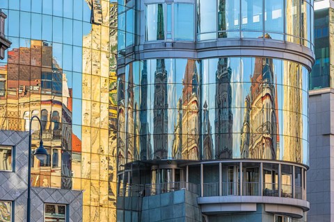 Historic buildings are reflected in the glass façade of the Haas House, Stephansplatz, Vienna,