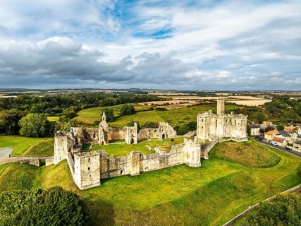 Warkworth Castle over River Coquet from a drone, Warkworth, Northumberland, England, United Kingdom