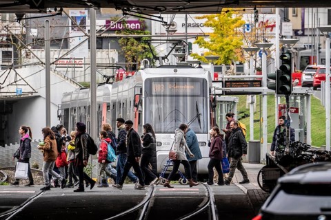 Pedestrians cross the tram tracks, at Düsseldorf-Bilk station, junction of S-Bahn, subway, tram,