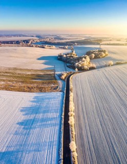 Bird Eye Perspective of Frost Covered Farmland. Seasonal Agricultural Scenery, winter and autumn