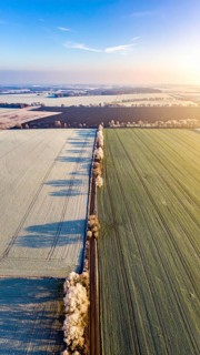 Bird Eye Perspective of Frost Covered Farmland. Seasonal Agricultural Scenery, winter and autumn