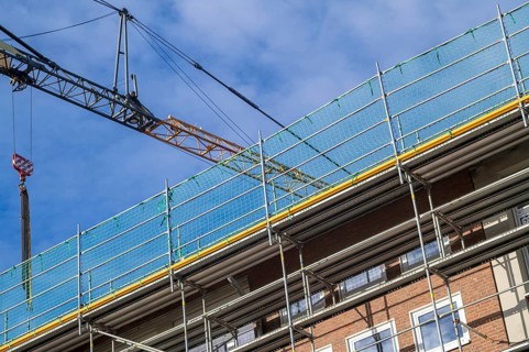Borken, NRW, Germany, RBuilding undergoing renovation with metal scaffolding and safety netting