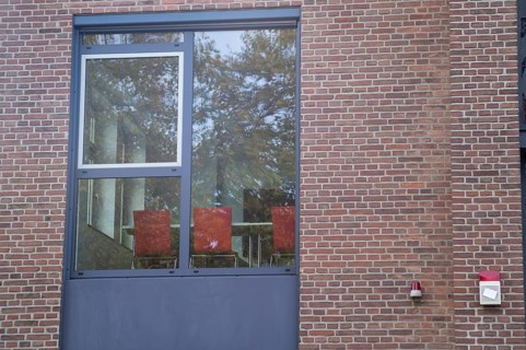 Borken, NRW, Germany, RExterior view of a contemporary office window showing trees reflected on