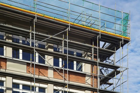 Borken, NRW, Germany, RBuilding renovation site showing scaffolding and protective nets against a