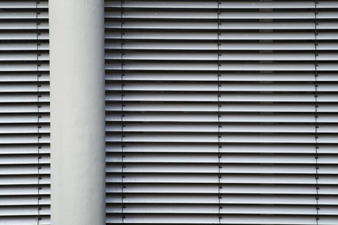 Borken, NRW, Germany, RModern building facade with horizontal lines from closed blinds and a