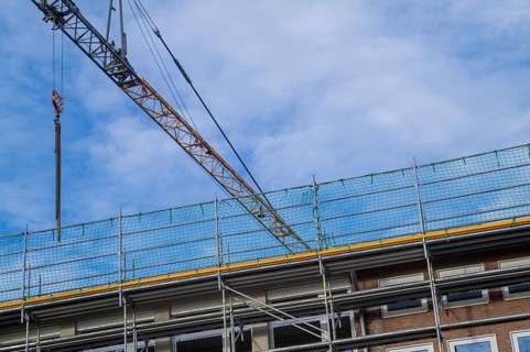 Borken, NRW, Germany, RConstruction crane and scaffolding against a blue sky, renovating a building