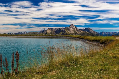 The panoramic lake at Saloberkopf with mountains in the background under a blue sky, Wart, Bregenz,