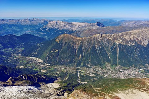 View from the Aiguille du Midi mountain station observation deck into the valley with the city,
