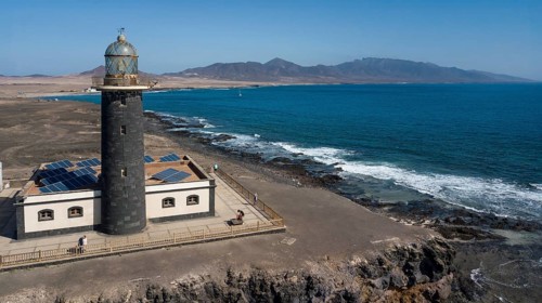 Aerial view of Faro Punta de Jandia lighthouse on a rocky outcrop at the southern tip of Jandia