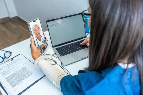 Healthcare professional having a video conference with a doctor on a smartphone while using a