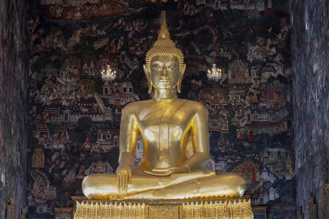 Golden Buddha statue, Phra Buddha Trilokachet surrounded by crystal chandeliers and exquisite wall