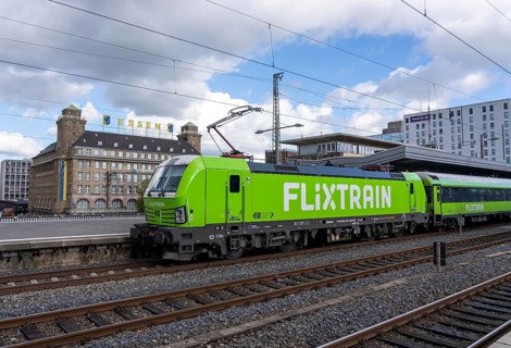 Flixtrain train on track 2 in Essen main station, view of the city center, Handelshof building with
