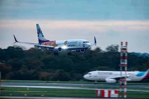 Sunexpress Boeing 737 landing at Düsseldorf airport, Eurowings aircraft waiting for takeoff, North