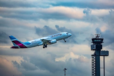 Eurowings Airbus A320 taking off from Düsseldorf Airport, Air Traffic Control Tower, North