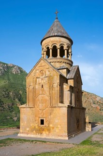 A church with ornate stone architecture against a clear blue sky, Noravank monastery, Surb