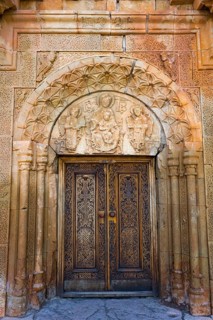 Elaborately carved wooden gate with beautiful stone decorations and architectural details, Noravank