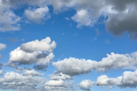 White clouds driven by approaching storm Cumulus Stratocumulus loose to thick cloud against blue