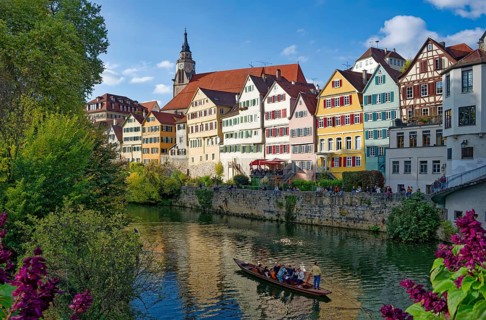 Historic houses on the Neckar front, the Neckar river with poking and water reflection, old town of