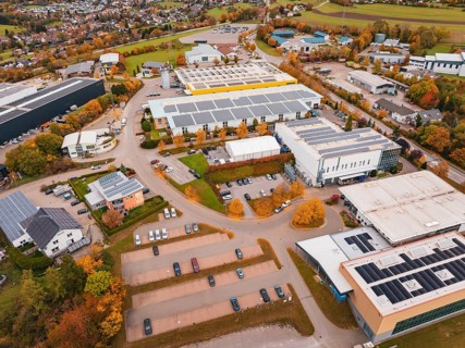 Industrial area with large buildings and parking spaces in an autumn environment, Dornstetten,