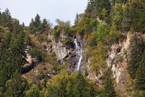 Waterfall with forest and mountains on Wilde Wasser Weg in autumn, WildeWasserweg, Stubai Valley,