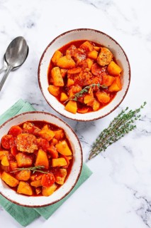 Meat goulash with potatoes and carrots, sweet peppers, in a saucepan, top view, traditional