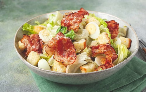 Caesar salad with fried bacon, quail eggs, homemade, no people