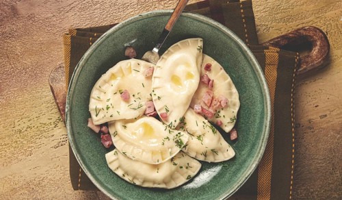 Dumplings, with fried prosciutto, a traditional dish of Polish cuisine, dumplings, top view,