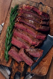 Fried steak, beef steak, rib eye steak, sliced steak, on a chopping board, top view, no people