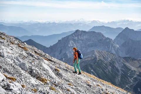 Female hiker on steep rocky slope, hiking to Gamsjoch, eastern Karwendel, Tyrol, Austria