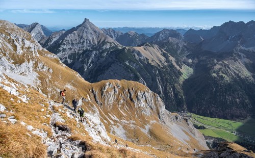 Hiker on a rocky mountain trail with a wide view of the valley, eastern Karwendel, Tyrol, Austria
