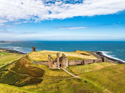 Dunstanburgh Castle from a drone, Northumberland Coast, England, United Kingdom