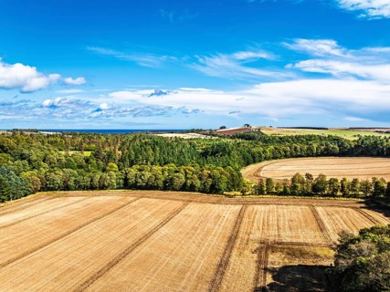 Farms and Fields over Ayton Castle from a drone, Ayton, Eyemouth, Scottish Borders, Scotland, UK