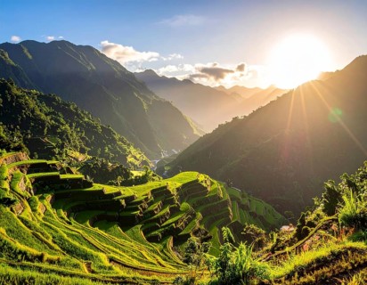 Early morning light bathes Philippines rice terraces cascading down mountain slopes, beautiful