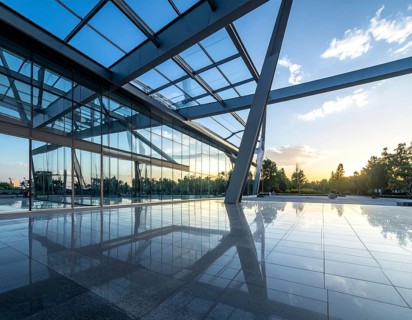 Modern architectural framework with glass and steel structure, glass facade with a greed of steel