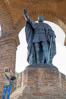 Woman photographing statue, Kaiser Wilhelm Memorial, Porta Westfalica, North Rhine-Westphalia,