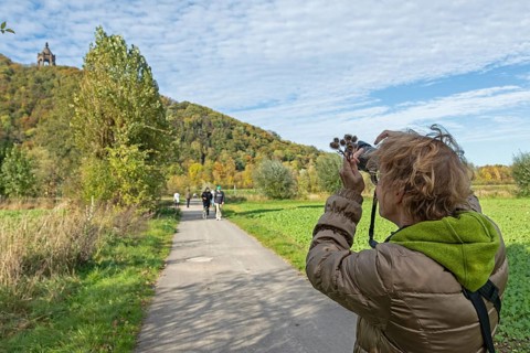Woman photographing Kaiser Wilhelm monument, mountain, forest, path, Porta Westfalica, North