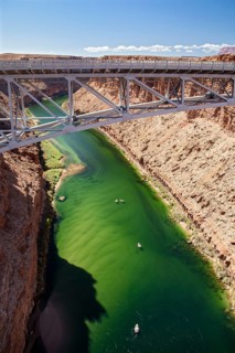 Marble Canyon, Arizona - Dories float under the Navajo Bridge which spans the Colorado River in