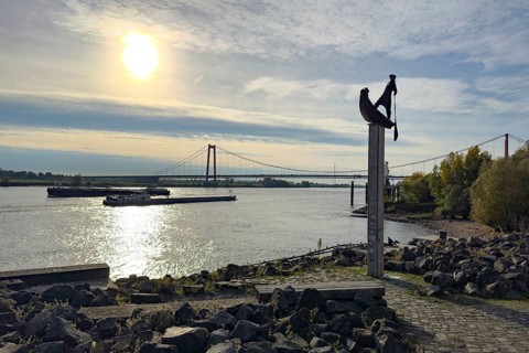 Photo with melancholy atmosphere of sculpture Fährmann Artwork on column stele by sculptor Dieter