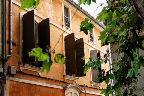 Facade, orange, shutters, Arles, France
