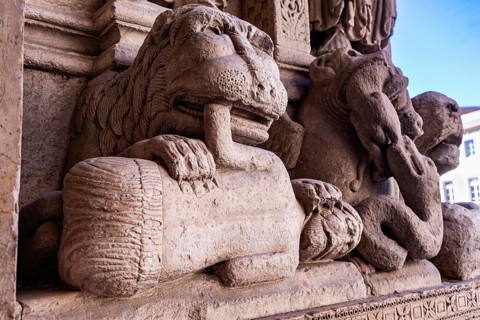 Lion eating man, sculpture at St. Trophime Cathedral portal, Arles, France
