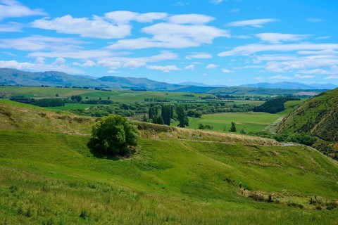 Green hills under blue sky with scattered clouds, rural and peaceful atmosphere, Canterbury, South