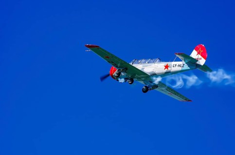 A Jakovlev Jak-52 with registration LY-HLZ during a flight demonstration as part of an air show on
