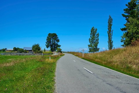 Rural road between green fields under clear sky, Geraldine Fairlie Lookout, Geraldine, Canterbury,
